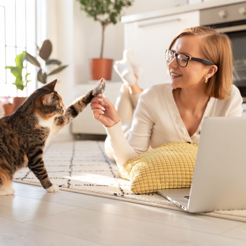 a woman and a cat high-fiving