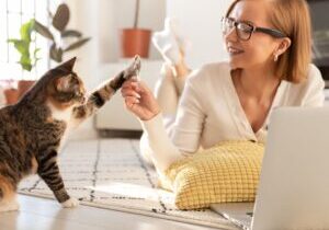 a woman and a cat high-fiving