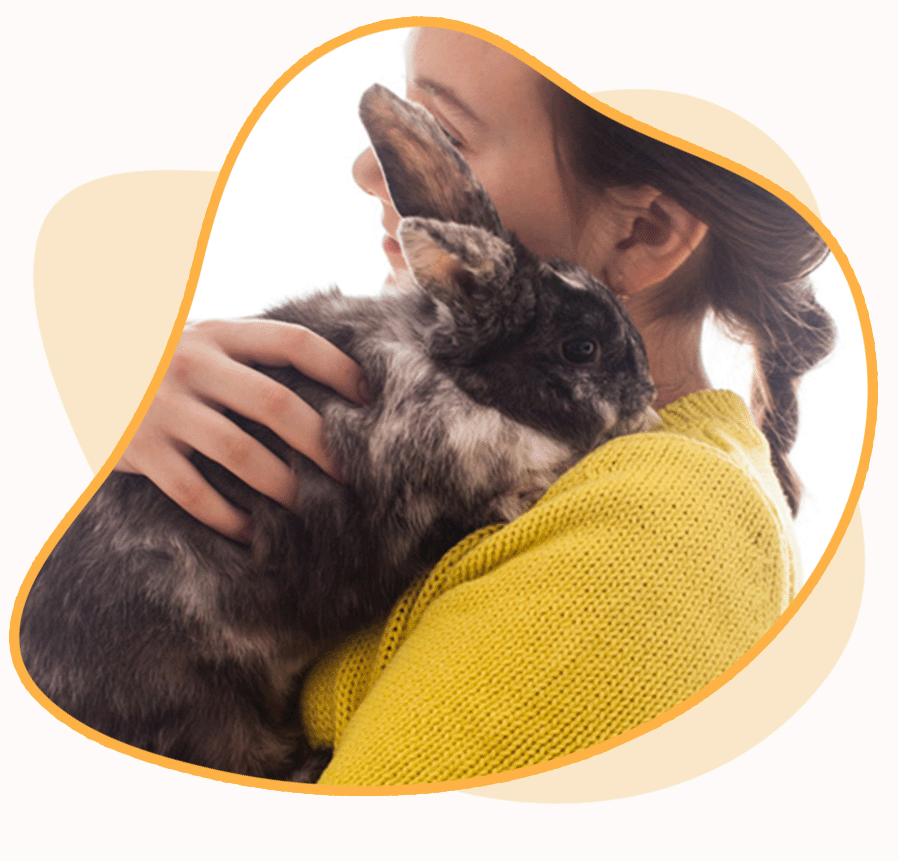 A person holding a bunny close to their chest